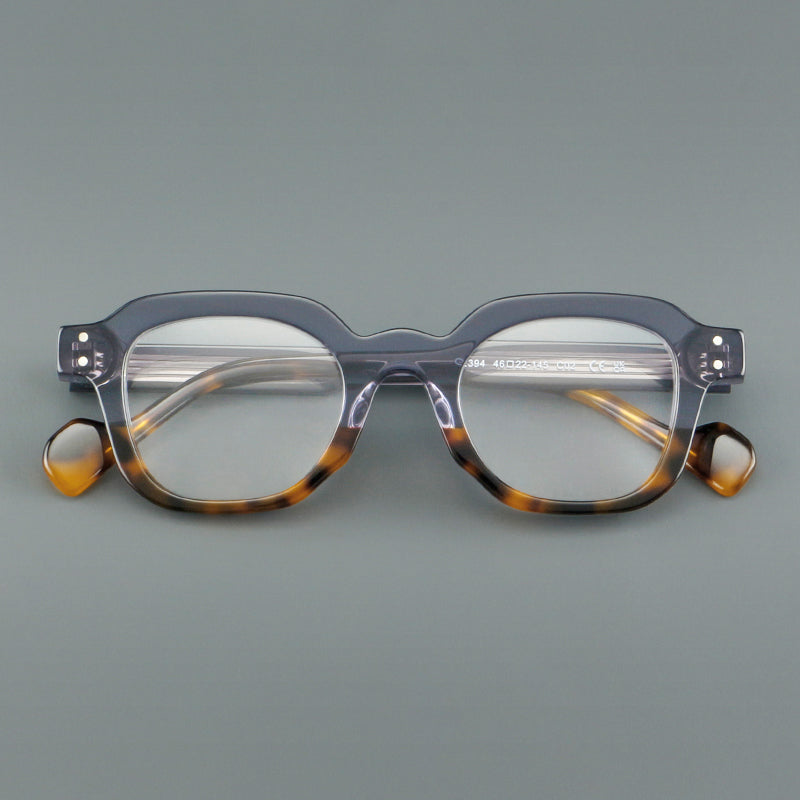 Monturas de gafas geométricas cuadradas de acetato con línea superior escalonada y detalles de remaches