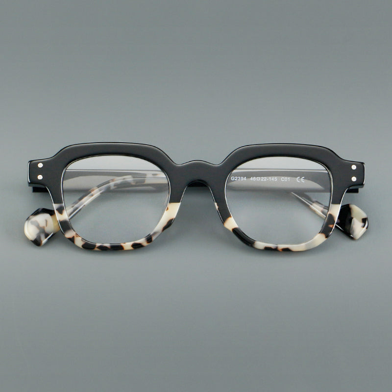 Monturas de gafas geométricas cuadradas de acetato con línea superior escalonada y detalles de remaches