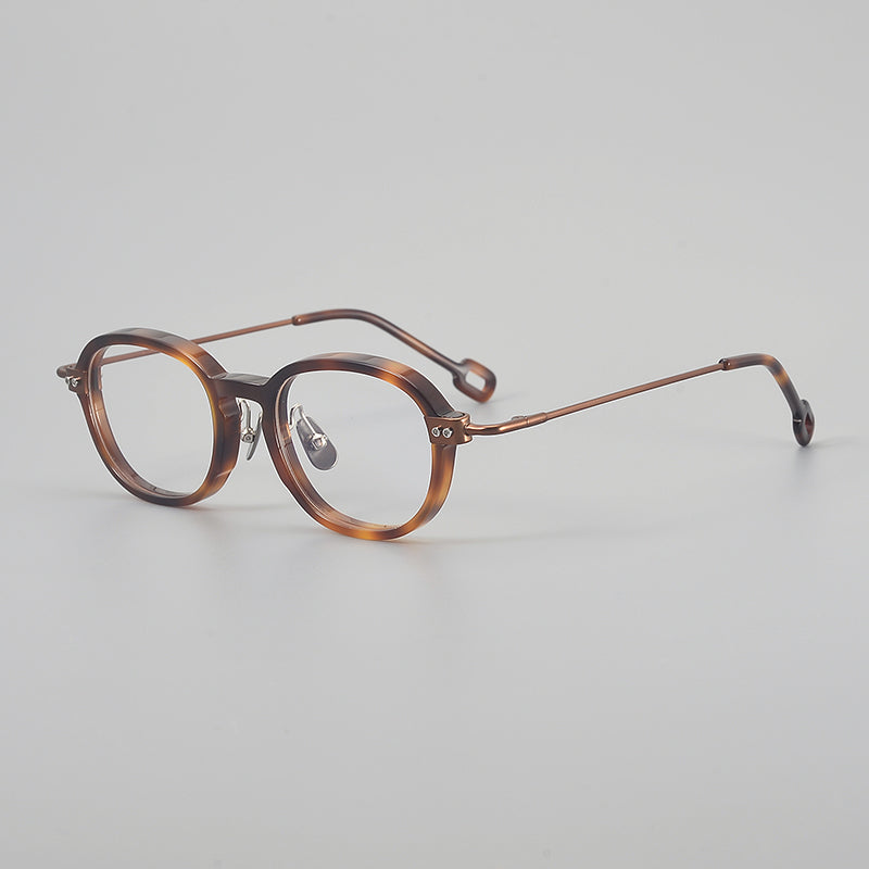 Monturas de gafas redondas retro de aleación de titanio con línea de cejas curva y detalles laterales de metal