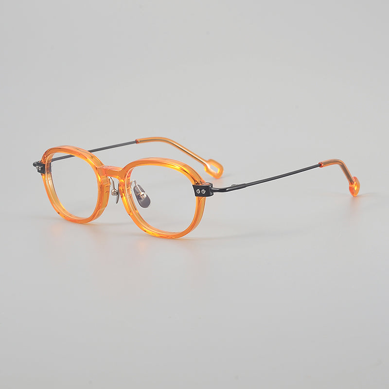 Monturas de gafas redondas retro de aleación de titanio con línea de cejas curva y detalles laterales de metal