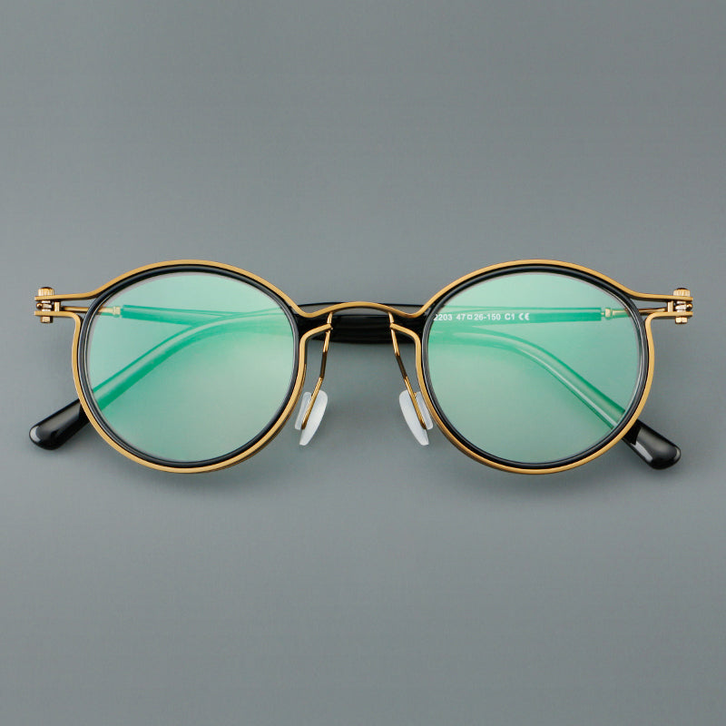 Monturas de gafas redondas vintage con diseño de borde superpuesto y detalle de puente metálico