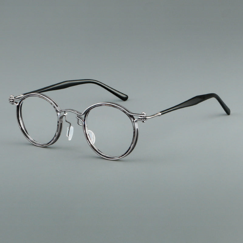 Monturas de gafas redondas vintage con diseño de borde superpuesto y detalle de puente metálico