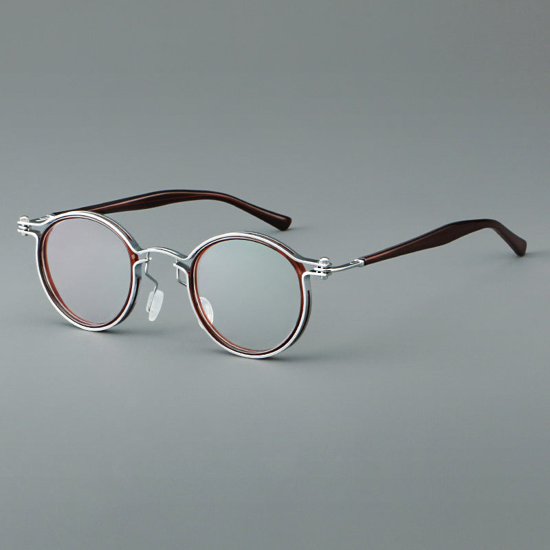 Monturas de gafas redondas vintage con diseño de borde superpuesto y detalle de puente metálico