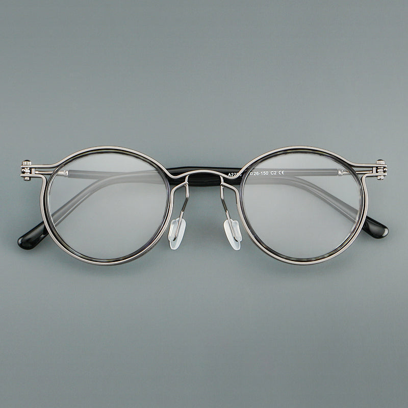 Monturas de gafas redondas vintage con diseño de borde superpuesto y detalle de puente metálico