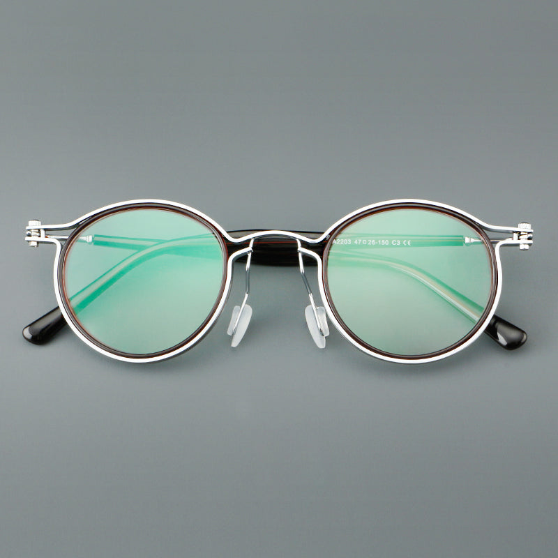 Monturas de gafas redondas vintage con diseño de borde superpuesto y detalle de puente metálico