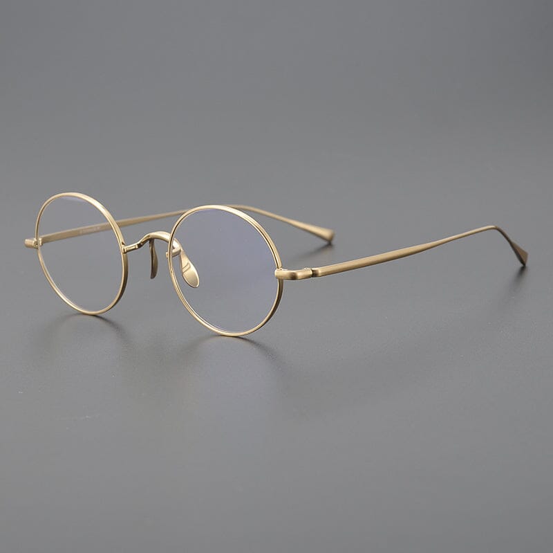 
Monturas de gafas redondas de titanio con aros de alambre fino y varillas metálicas delgadas - Oro