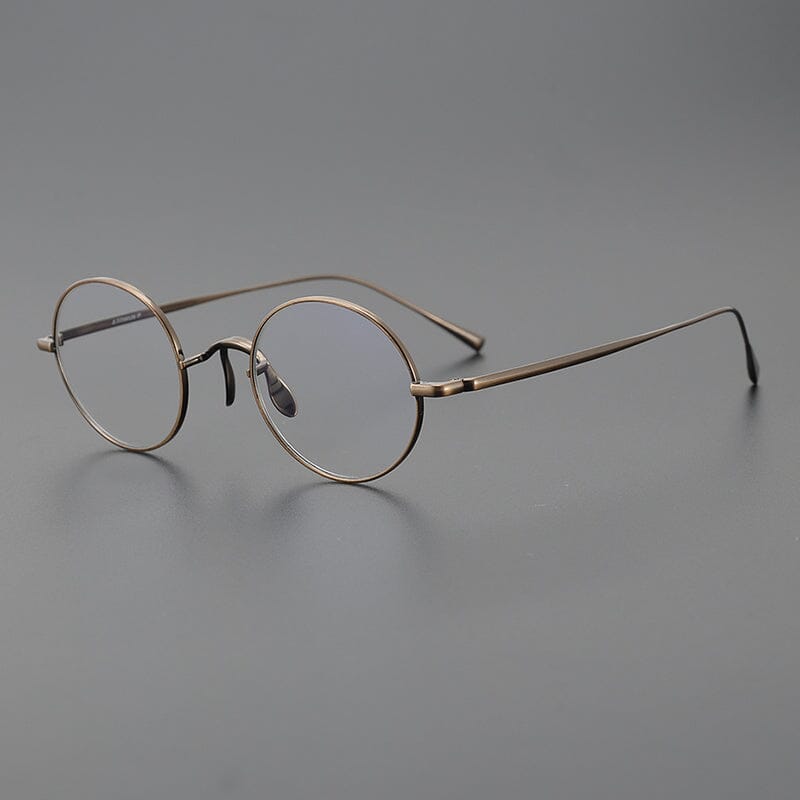 
Monturas de gafas redondas de titanio con aros de alambre fino y varillas metálicas delgadas