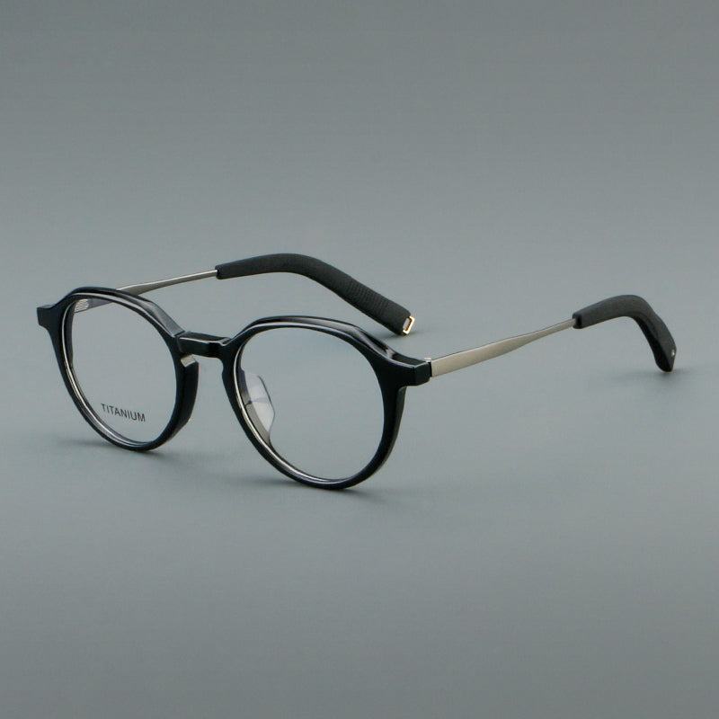 
Monturas de gafas redondas de aleación de titanio con borde superior esculpido y puente metálico - Negro y plata
