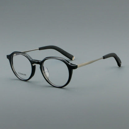 
Monturas de gafas redondas de aleación de titanio con borde superior esculpido y puente metálico