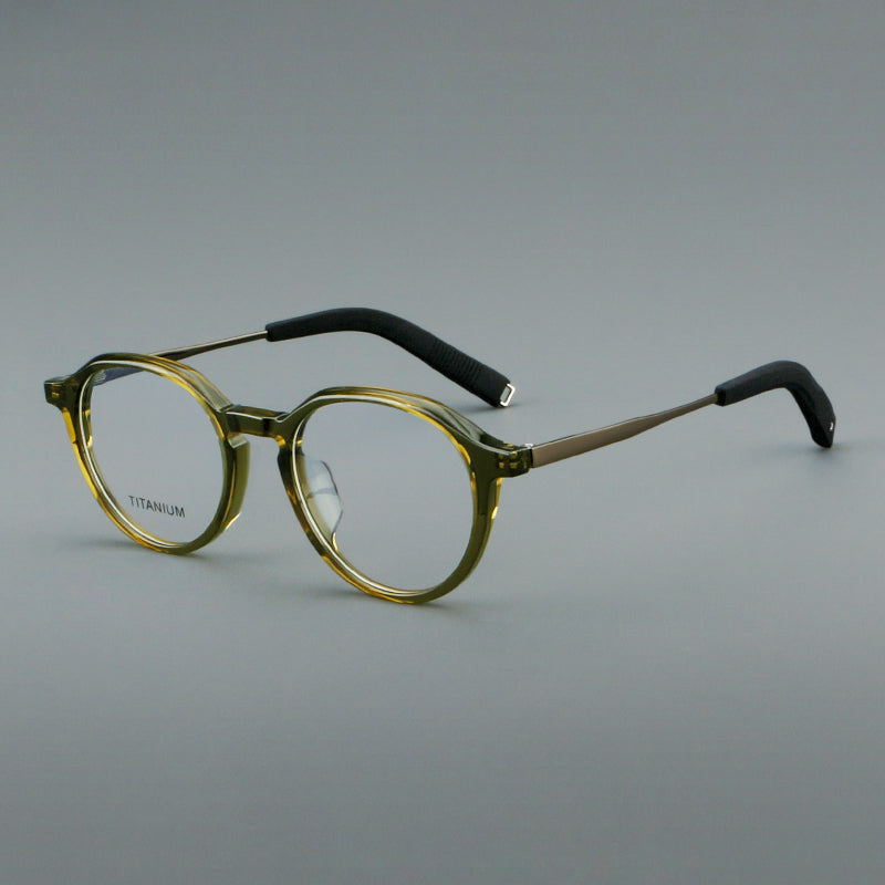 
Monturas de gafas redondas de aleación de titanio con borde superior esculpido y puente metálico