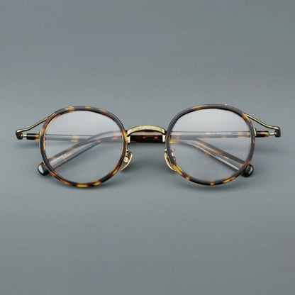 
Montura de gafas redondas retro de acetato con puente de metal fino y detalles laterales - Imagen 8
