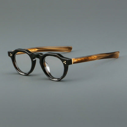 
Monturas de gafas vintage de acetato con forma geométrica, borde superior facetado y puente de cerradura