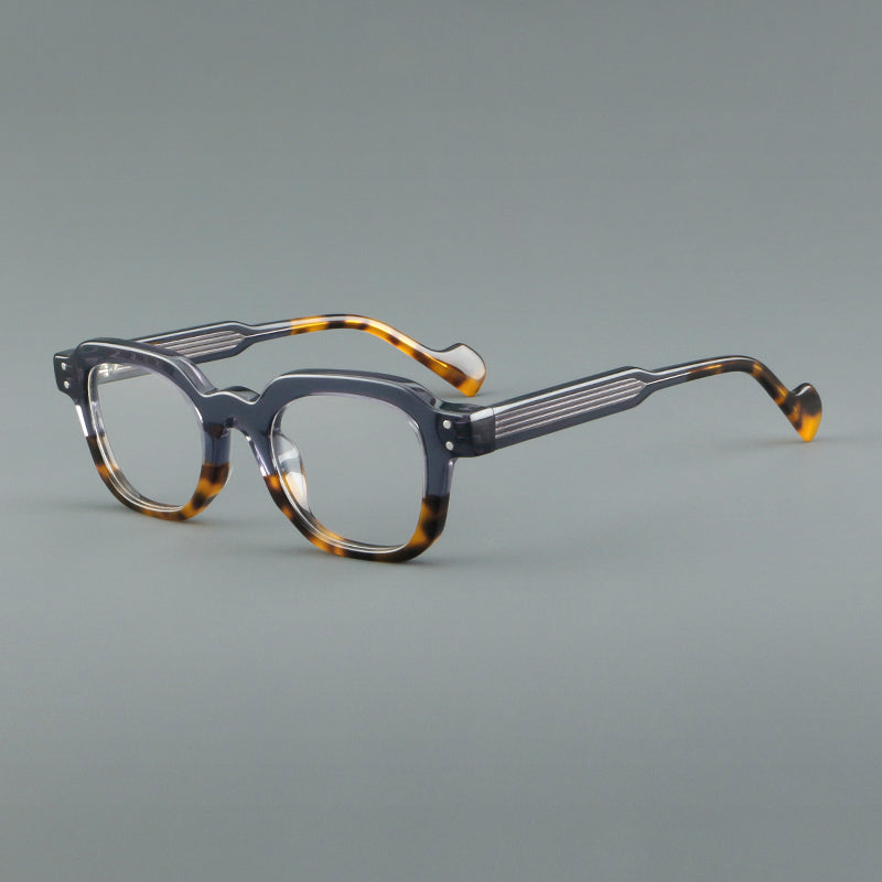
Monturas de gafas geométricas cuadradas de acetato con línea superior escalonada y detalles de remaches