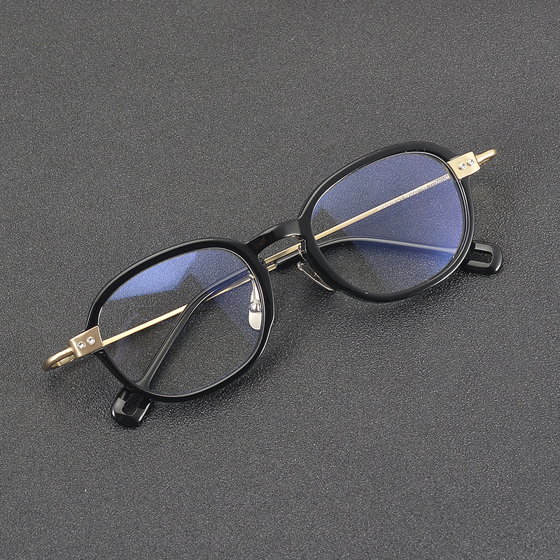 
Monturas de gafas redondas retro de aleación de titanio con línea de cejas curva y detalles laterales de metal - Imagen 2