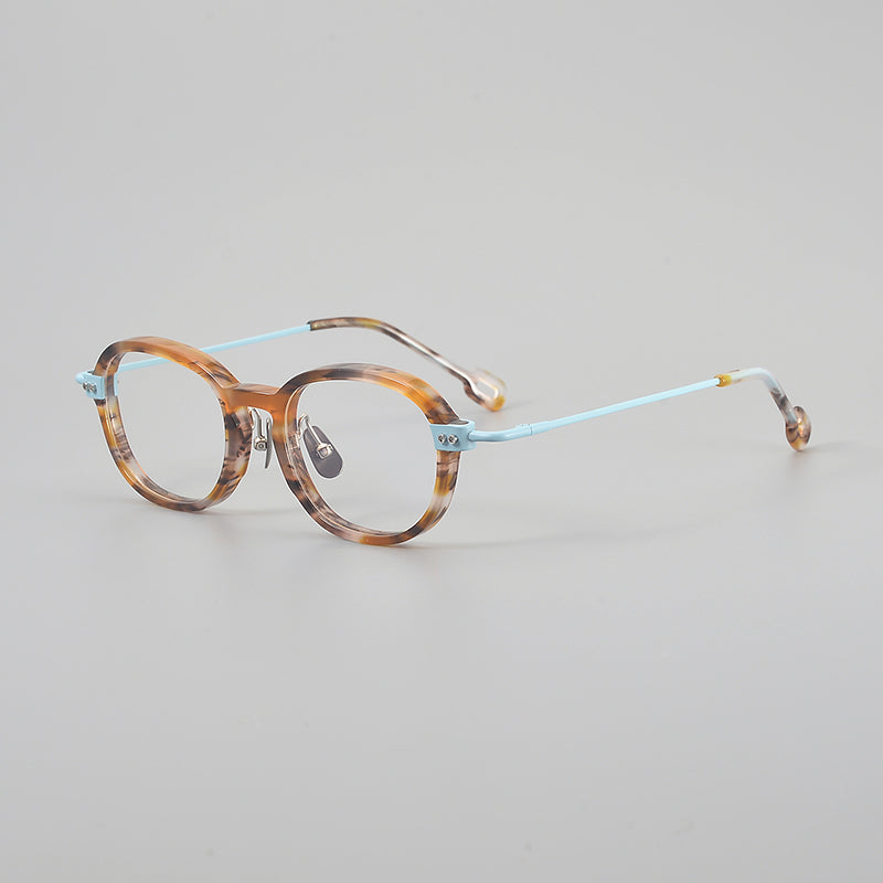 
Monturas de gafas redondas retro de aleación de titanio con línea de cejas curva y detalles laterales de metal
