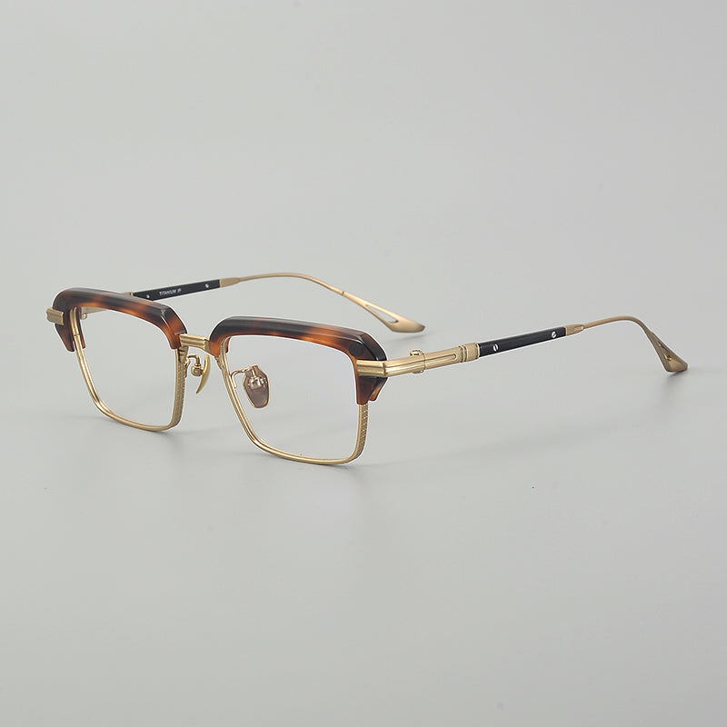 
Monturas de gafas rectangulares vintage de titanio con línea superior definida y bordes inferiores de metal fino