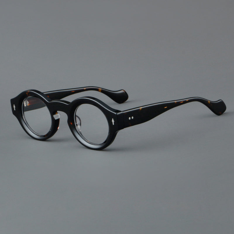
Monturas de gafas retro redondas de acetato, bordes circulares gruesos y detalles laterales esculpidos