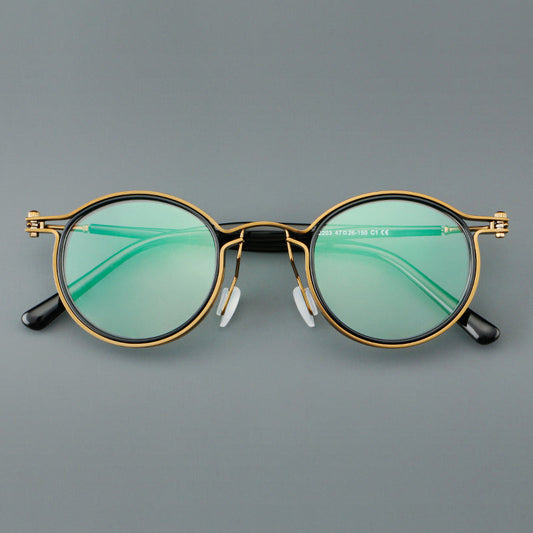 Monturas de gafas redondas vintage con diseño de borde superpuesto y detalle de puente metálico