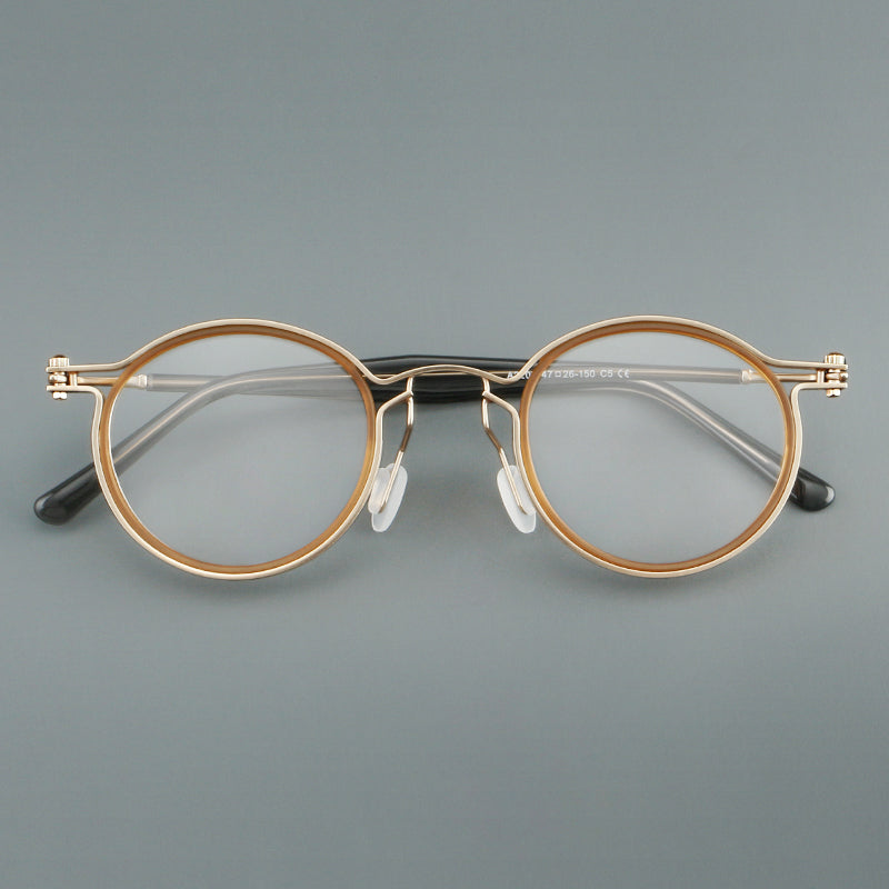 
Monturas de gafas redondas vintage con diseño de borde superpuesto y detalle de puente metálico