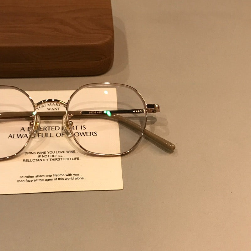 
Monturas de gafas geométricas de estilo alambre con puente fino, tono dorado