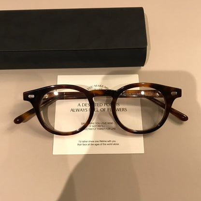 
Montura de gafas redonda retro con borde superior ancho, carey o negro brillante